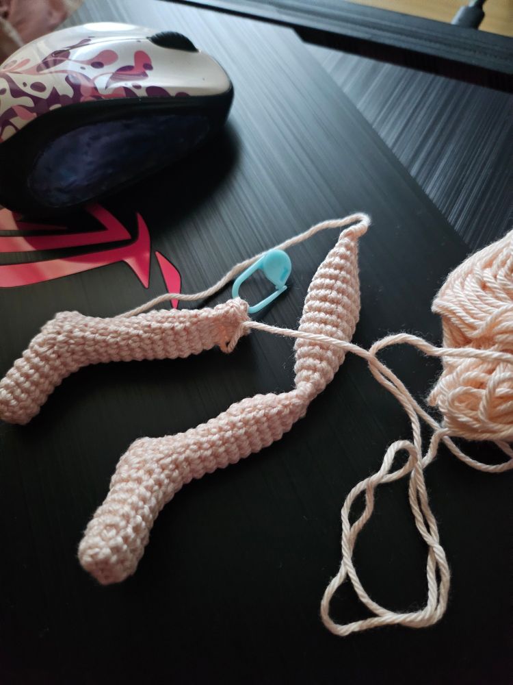 two crochet doll legs, one half finished