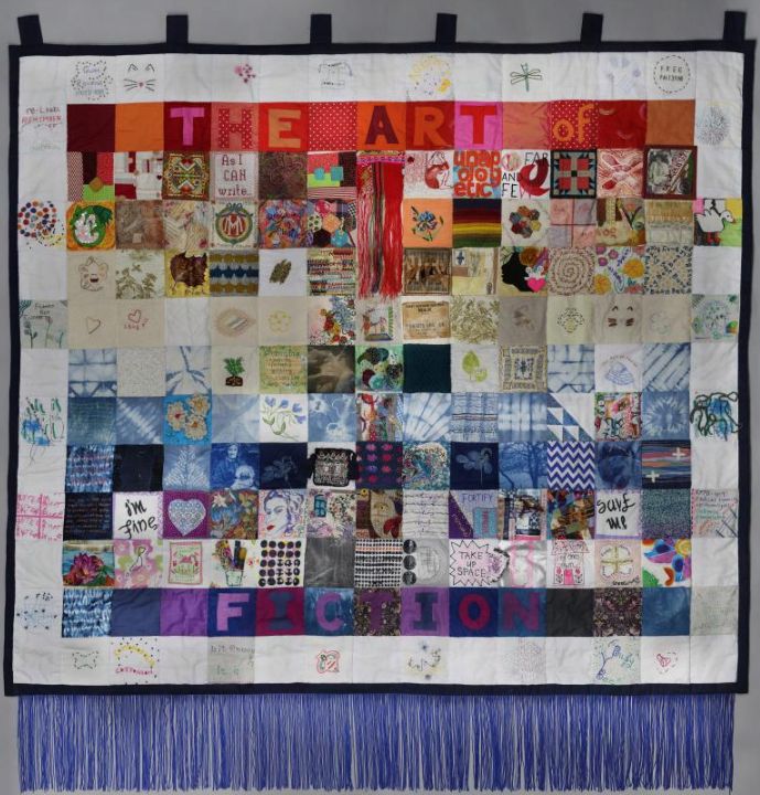 Women’s Work (2024) is an artwork created by Ruth Broadway from patches sent to us by over 100 contributors as part of our Patchwork Object Project.

The object was made in Bristol in late 2024 and is composed of 195 patches, including the 148 patches we recieved from contributors around the world. It is a multimedia work that responds to the long tradition of banner making in feminist art; a pole can be threaded through loops of fabric at the top of the work, for it to be hung, carried, marched, celebrated. A fringe of tassels at the bottom of the work responds to textural elements in the patchwork and compounds the jubilant mood of the work. 

Contributing artists, makers, and crafters responded to a call for patches themed around "women's creative identities and lives". Women's Work is the result of that collaboration. More information about the call can be found on the home and "About" pages of this website.