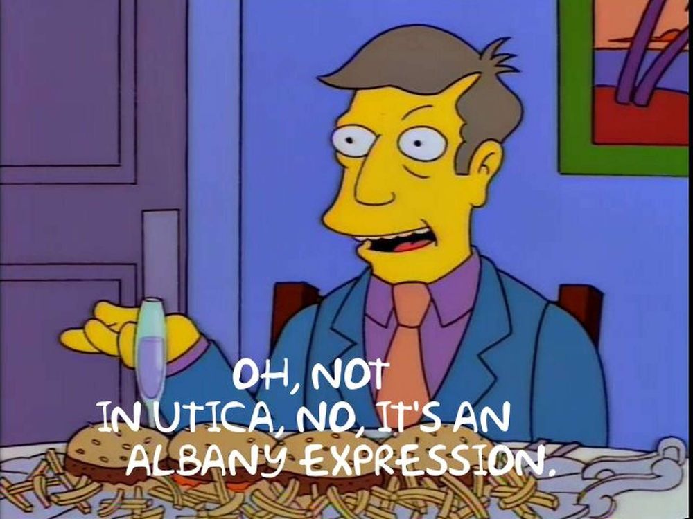 Screenshot from the Simpsons. Principal Skinner is seated at a table about to tuck into a plate of steamed hams, saying, "Oh, not in Utica, it's an Albany expression."