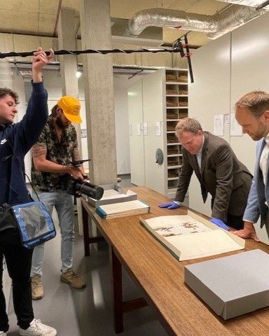 CUBG Curator, Sam Brockington and Cambridge Distillery Co-Founder William Lowe being filmed for the Drink documentary in the Cambridge University Herbarium, looking at one of Charles Darwin's specimens from the HMS Beagle Voyage