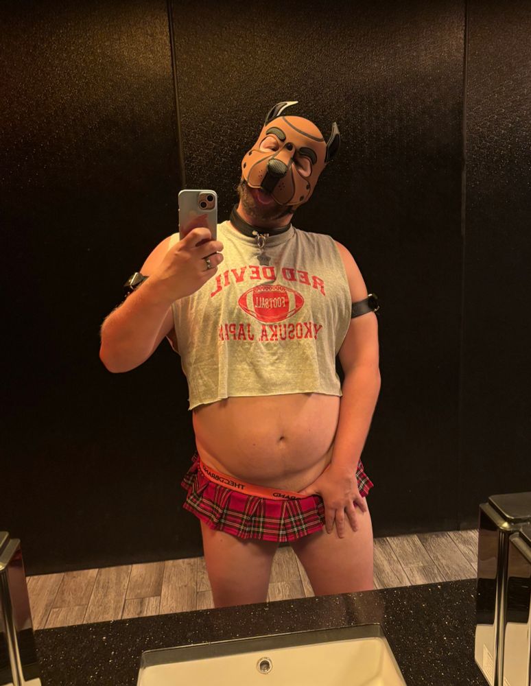 Cub Rye wearing a jockstrap skirt and showing his tummy wearing a pup hood