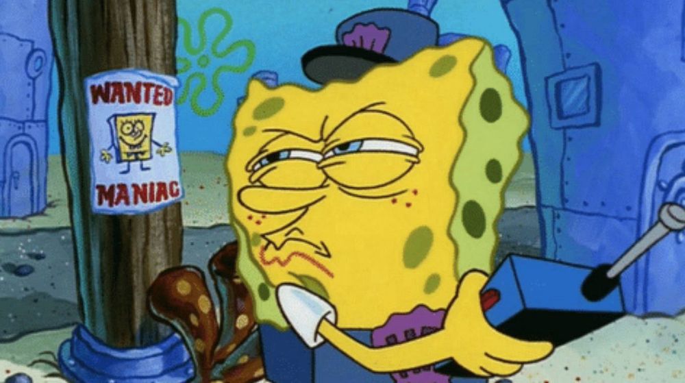 SpongeBob looking at a poster that reads “Wanted Maniac” with his likeness on it