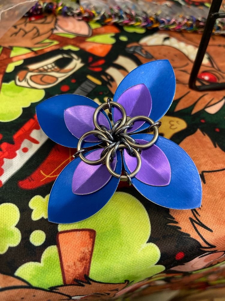 A 4 petal scalemaille flower in purple and blue