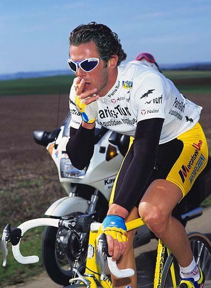 Mario Cipollini smoking on the bike where the cigarette may not be the strangest thing in the photo. 