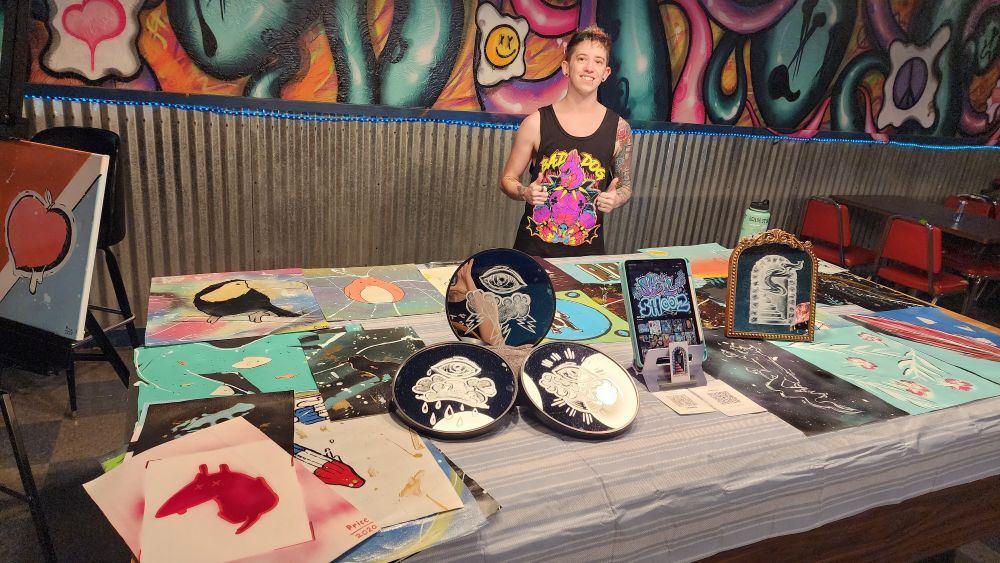 Me standing behind by art table at Side Quest on 44th in Lawrenceville for the art crawl