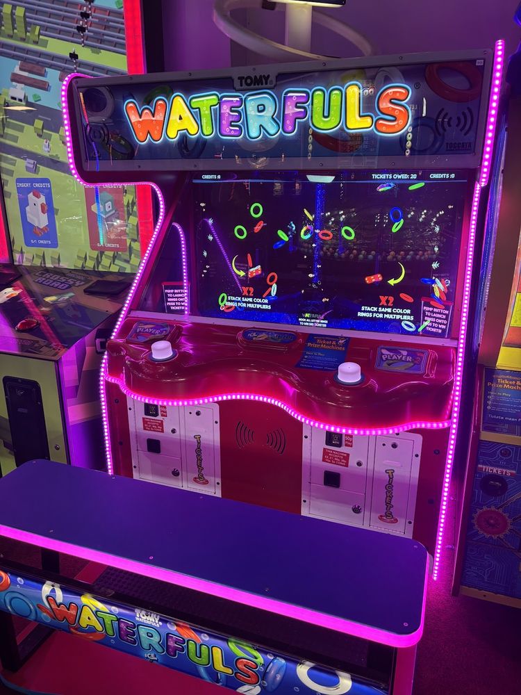 A Tomy Waterfuls arcade machine in all its lurid glory. Hit a button to power chaotic floating rings around a screen, like you used to in the 1980s except now consuming a lot of electricity instead.