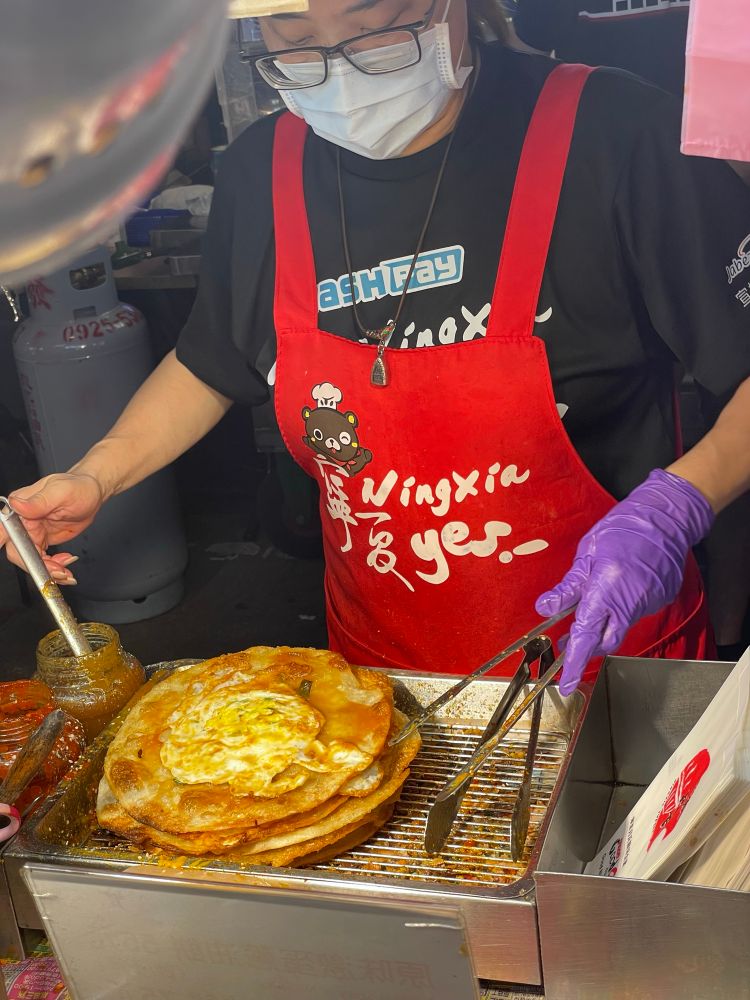 Look at this delicious scallion pancake with eggs that costs a quarter from one of Taipei’s many night markets 