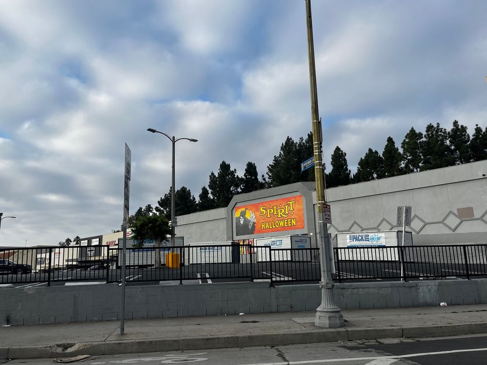 Storage containers in front of a Spirit Halloween store