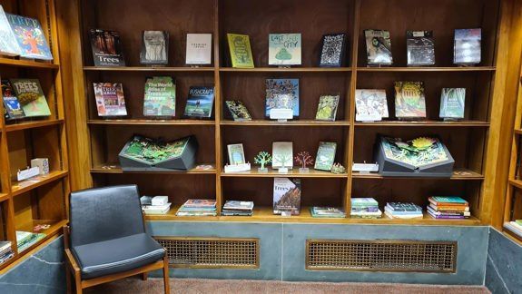 shelves with books about trees and forests