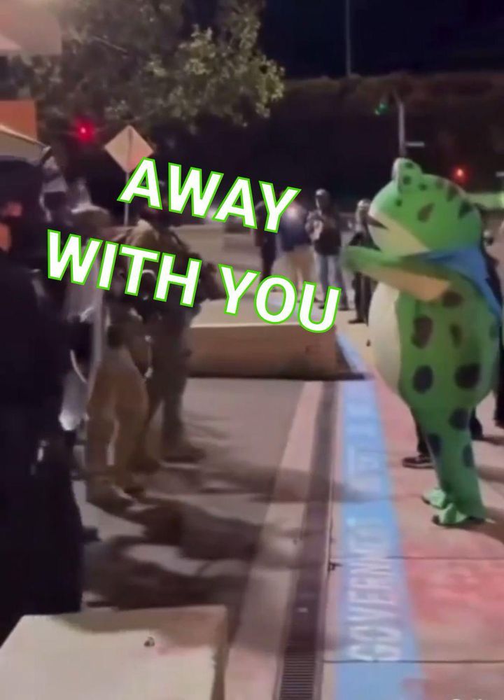 PDX hypno frog in a blue cape standing on 2 legs waving tiny arms at ICE police
Text reads “AWAY WITH YOU” 