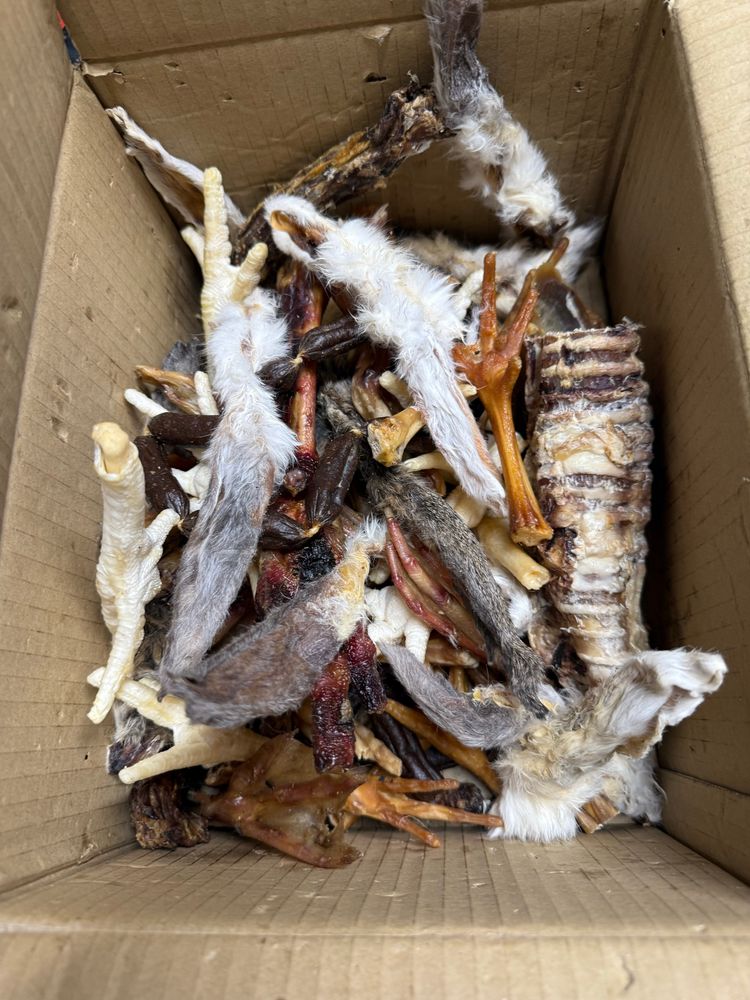 Delicious box of dried animal parts, rabbit ears, cow oesophagus, chicken feet, specifically designed to allow your dog to vomit on the bed and leave the hair remnants 