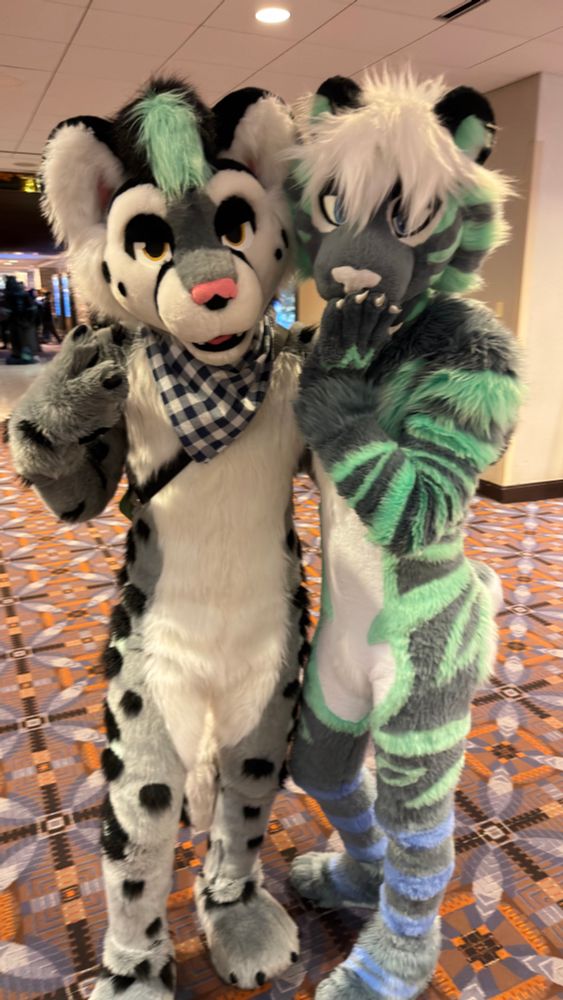 Two minty colored cat fursuiters