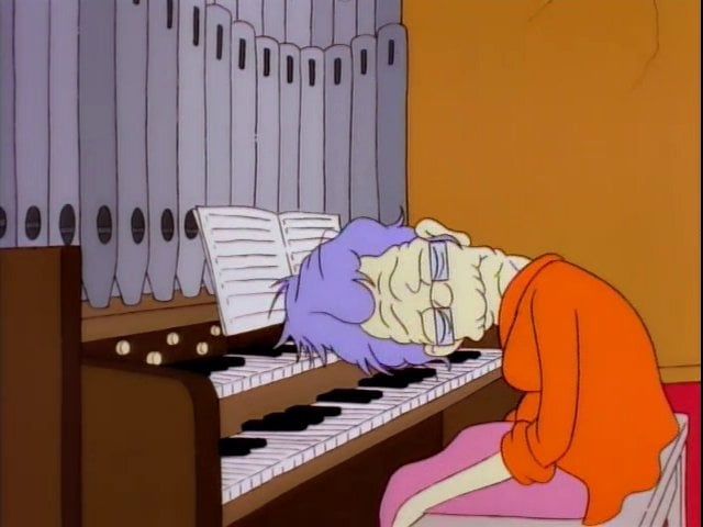 Frame from The Simpsons of an organ player collapsed on the organ.