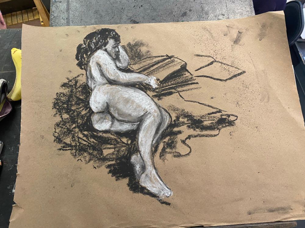 Charcoal drawing of nude woman flipping thru books 