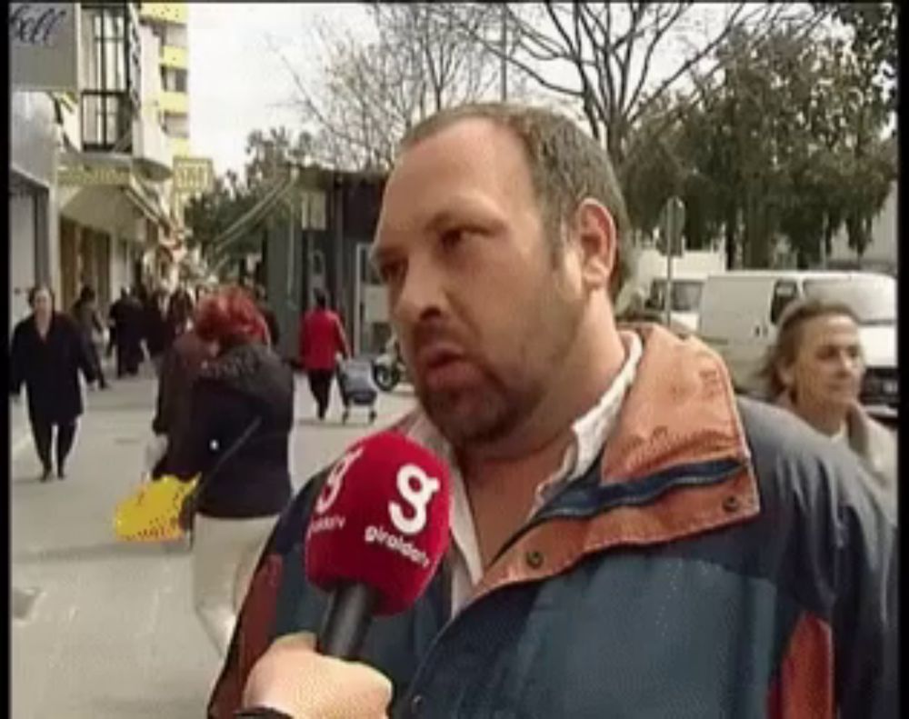 a man wearing a jacket with a red microphone that says g on it