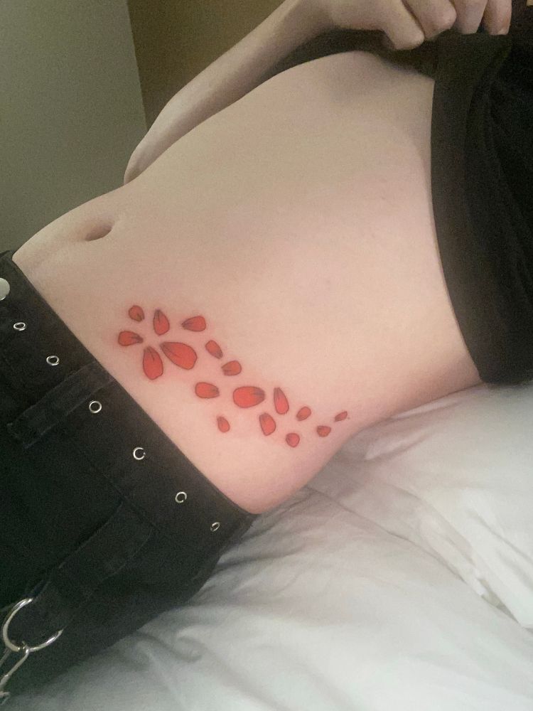 A waist tattoo depicting rose petals. It is inspired by the animation RWBY. the same copy is on the other side. 