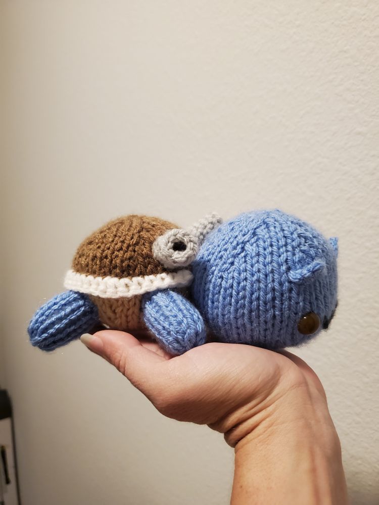 A side view of a knitted Blastoise plushie