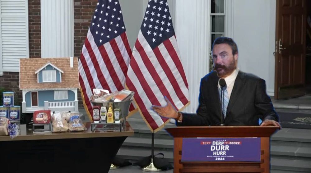 This is me posing at a lectern, wondering why anyone would be posing at a lectern -- basically mad at the whole thing and I have a pot roast on the stove I think is burning brb dammit all to hell.