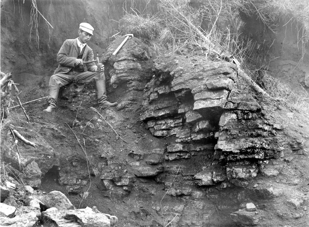 Vanha mustavalkokuva miehestä istumassa sorakummun päällä hakku kädessään.

Dioriittilouhos ja irroitettuja sortavaliittilohkareita. Kuva: Hugo Berghell, 1892.