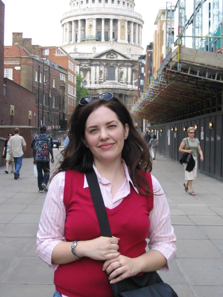 Me, in front of St Paul's cathedral in a read shweater in 2004. Whoever took the picture cut off the top of the building. 