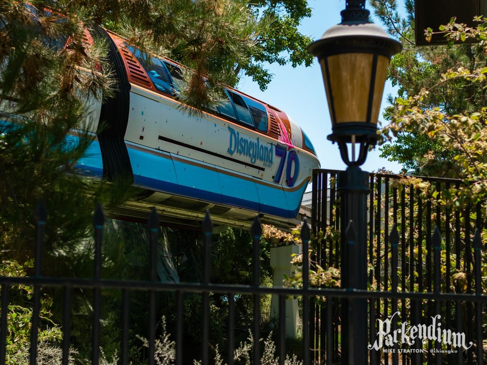 Photograph of a Disneyland Monorail passing by the Matterhorn in Fantasyland at Disneyland, with a Disneyland 70 overlay.