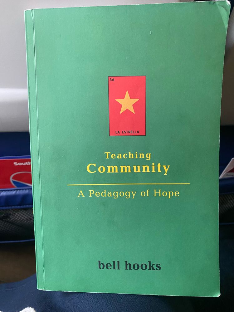Green book cover for bell hooks Teaching Community A Pedagogy of Hope. Cover includes red square with gold star in the middle and the words “la estrella”