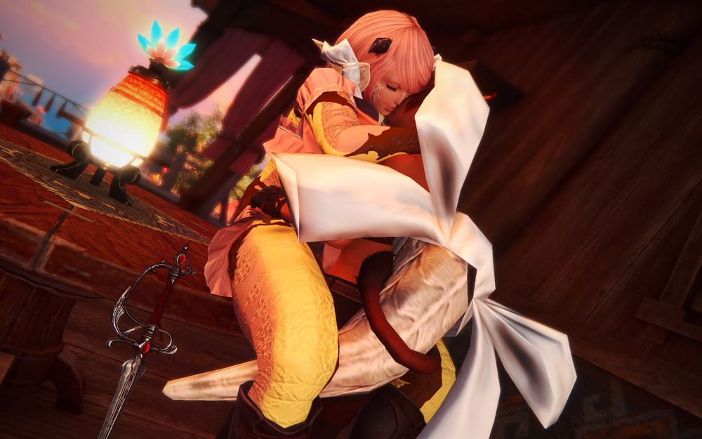 An image of two characters in the critically acclaimed final fantasy 14
The smaller one, a red haired cat girl is pushing the taller one, a pink haired dragon girl onto the rim of a table.
The two are kissing and their tails are embracing
