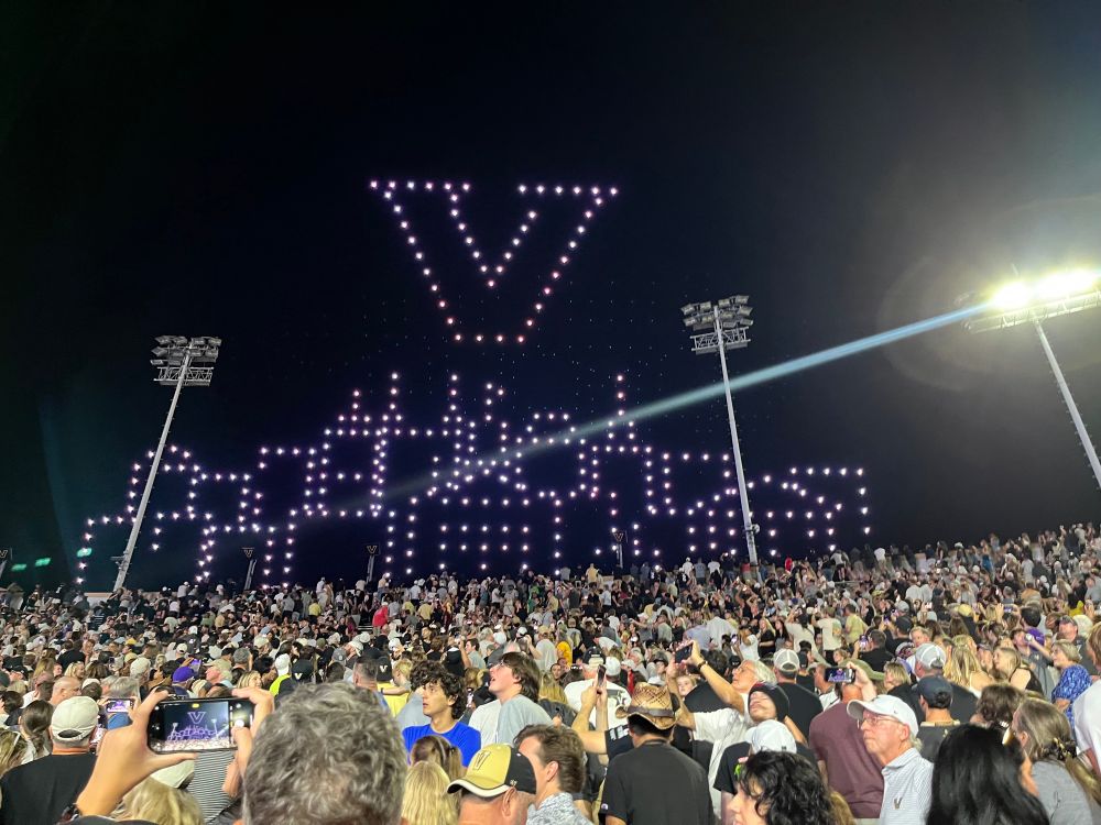 Photos of a drone show at the Vanderbilt football game halftime show. A giant V in over the Nashville sky line in the sky