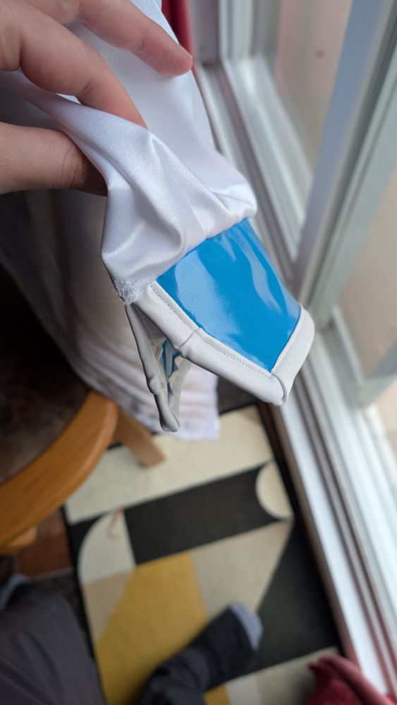 Sleeves finished with a blue vinyl border.