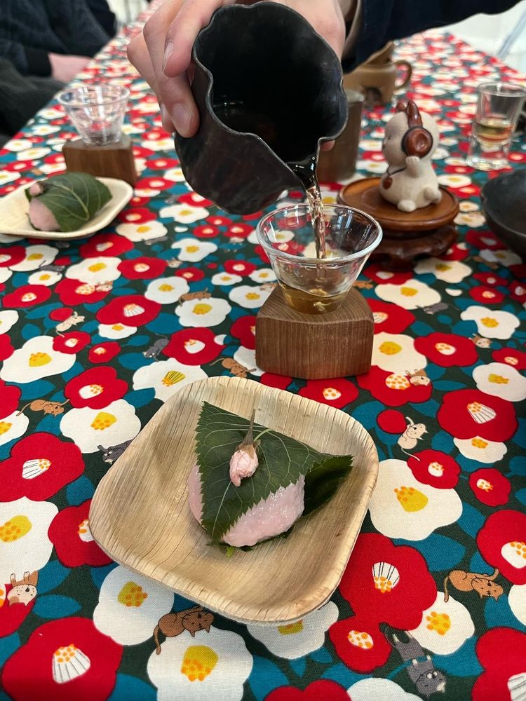 Mochi with oolong being poured in the background 