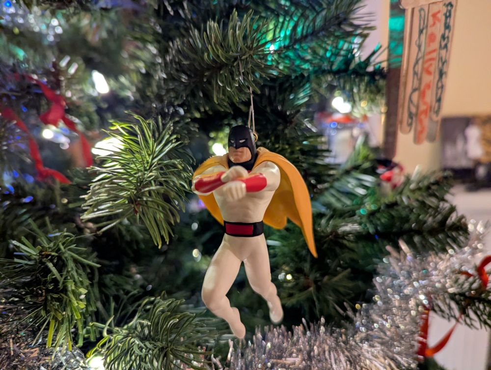 A Space Ghost Christmas ornament, he looks like he's fixin to blast Zorak with his wrist blaster 