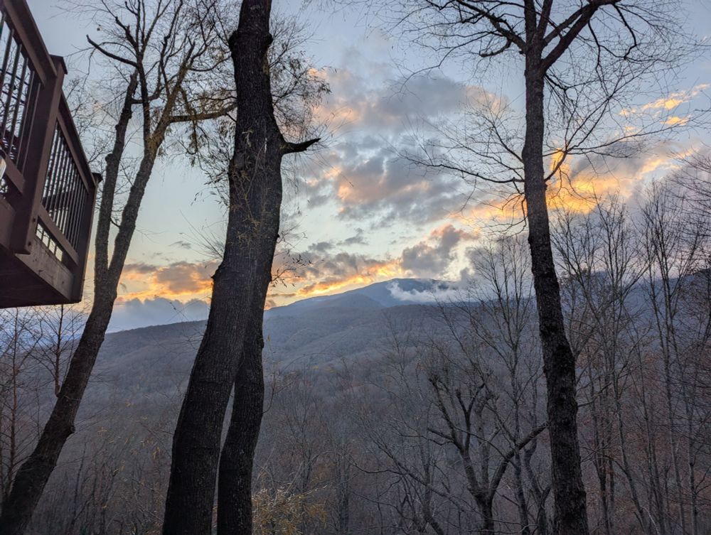 Mt Mitchell NC with some whispy clouds and golden sunset light, bare trees