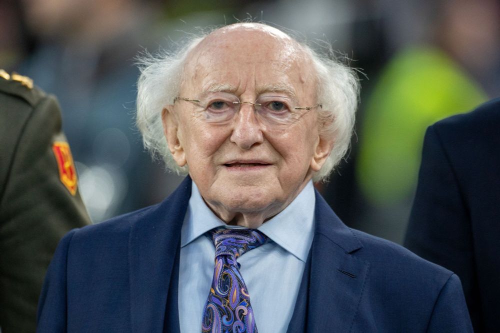 Micheal D. Higgins, President of Ireland, an elderly white man with a round face and white fur gathered around his ears