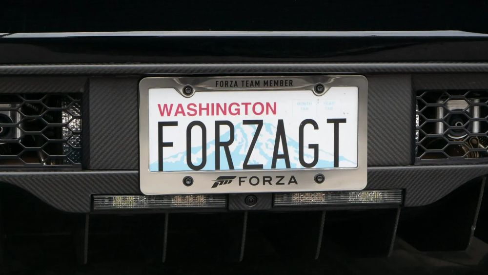 Close up of a car license plate that says "Forza Team Member, Washington, Forza GT, Forza"