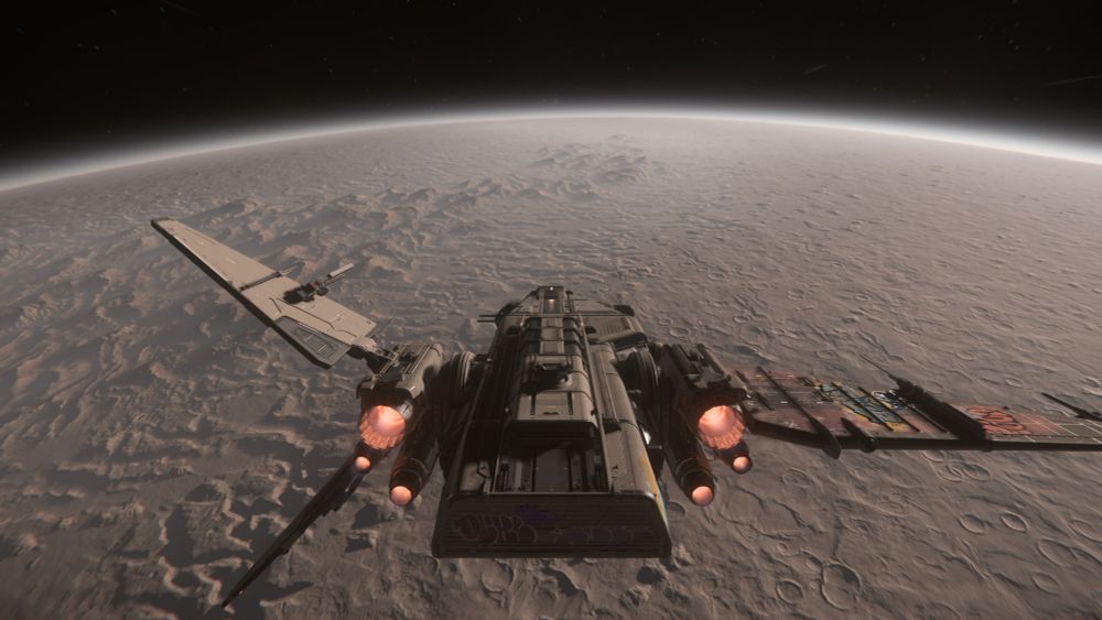 A screenshot from Star Citizen of a Drake Corsair flying toward the horizon of the desert moon Daymar
