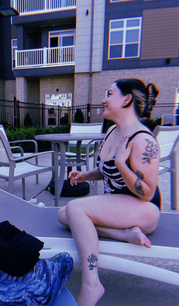 Pic of me at the pool in my apt wearing a skeleton print bathing suit 