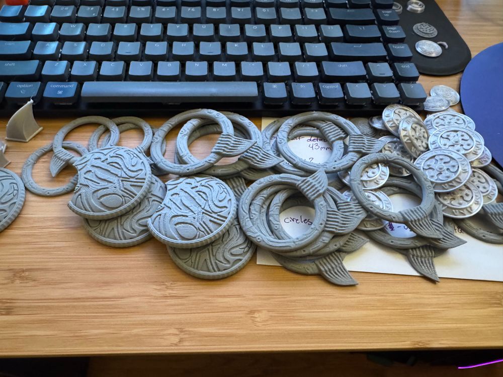 A pile of 3D printed costume ornaments for a Karlach from Baulder’s Gate 3 cosplay.