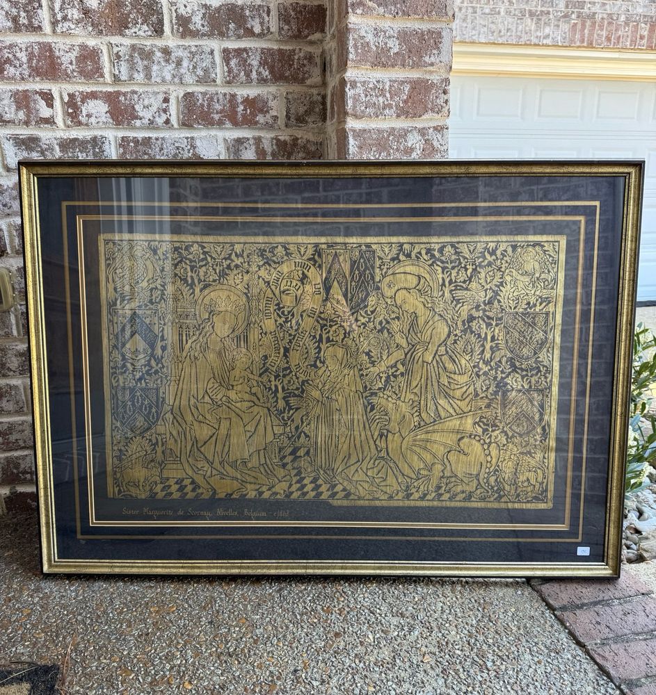 A framed brass rubbing of a scene titled “Sister Marguerite De Scornay, 1462” from the 7th Century Abbey of Nivelles in Belgium.