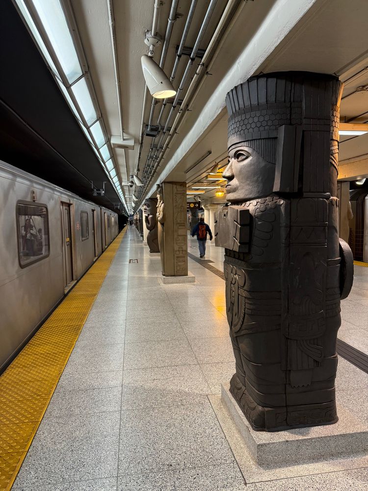 Picture at the TTC station "Museum" where the pillars have hieroglyphics on them.