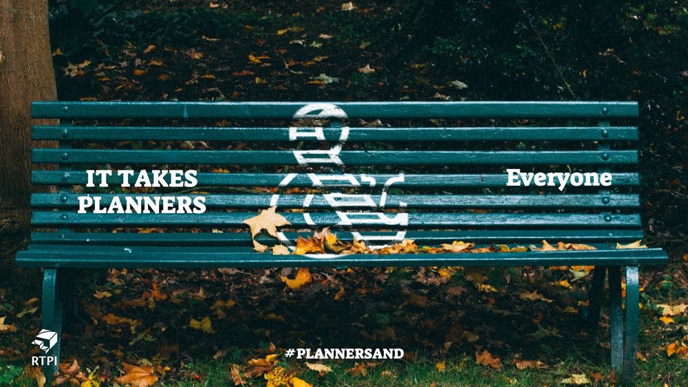 A green bench with white writing on it saying It takes planners & everyone