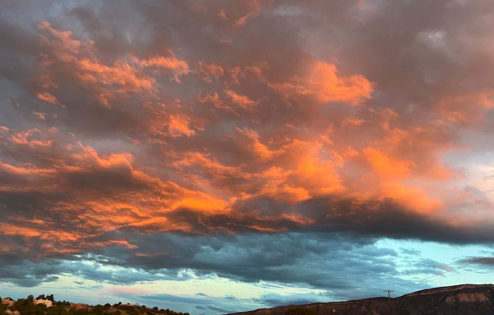 A new mexico sunset lighting up pink and blue clouds 