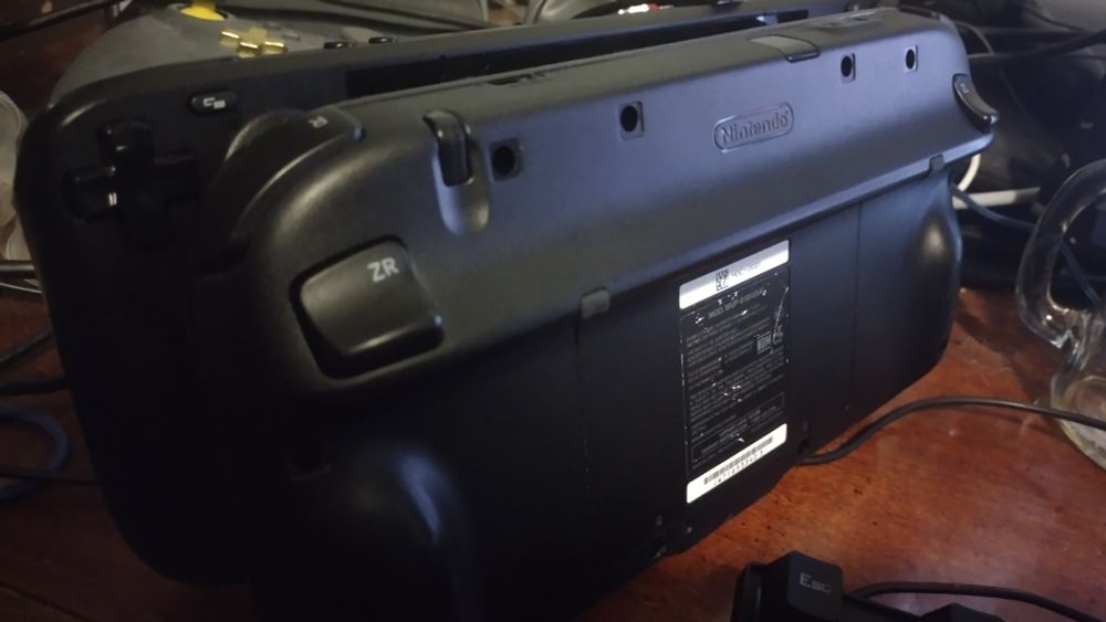 A Wii U gamepad leaning on top of a steam deck with the screens facing each other as if to kiss