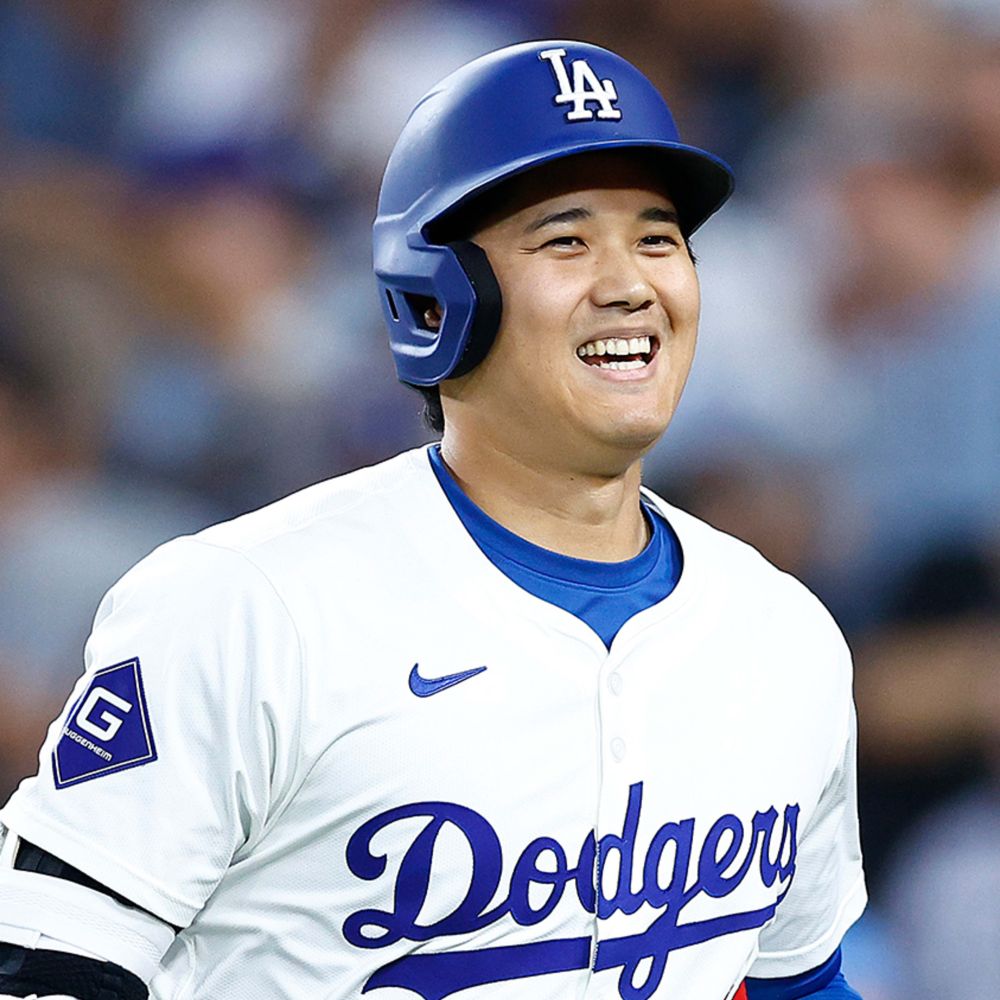 Shohei Ohtani smiles while running in his Dodgers uniform