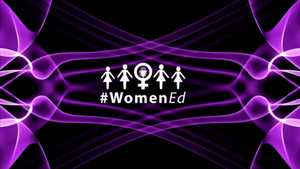 a sign that says #womened with purple waves