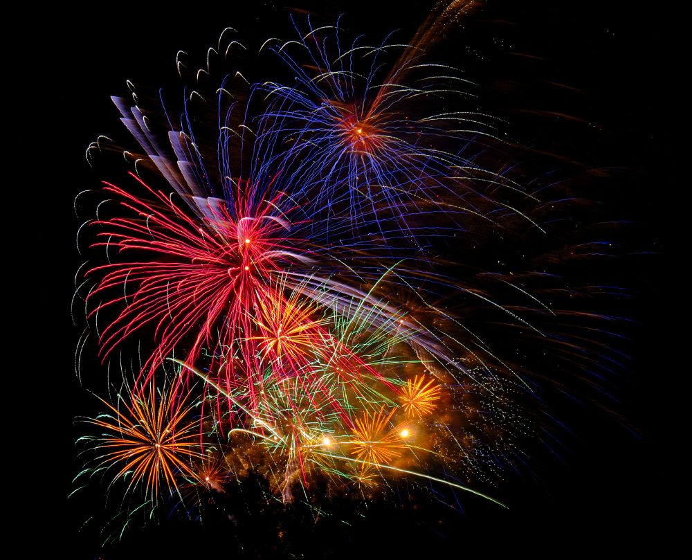 Local fireworks in blue, red, green, and yellow combined