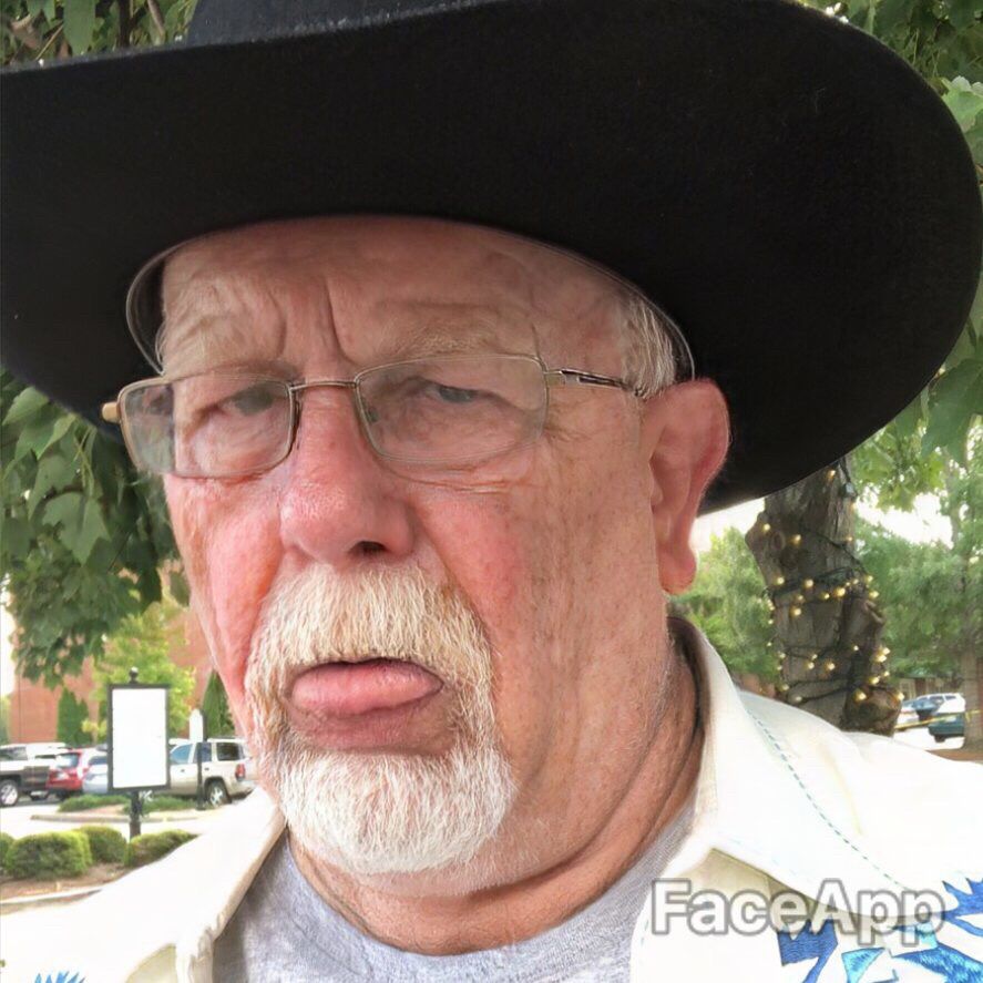 Man (actually me) in a cowboy hat, looking old and sad and tired.  