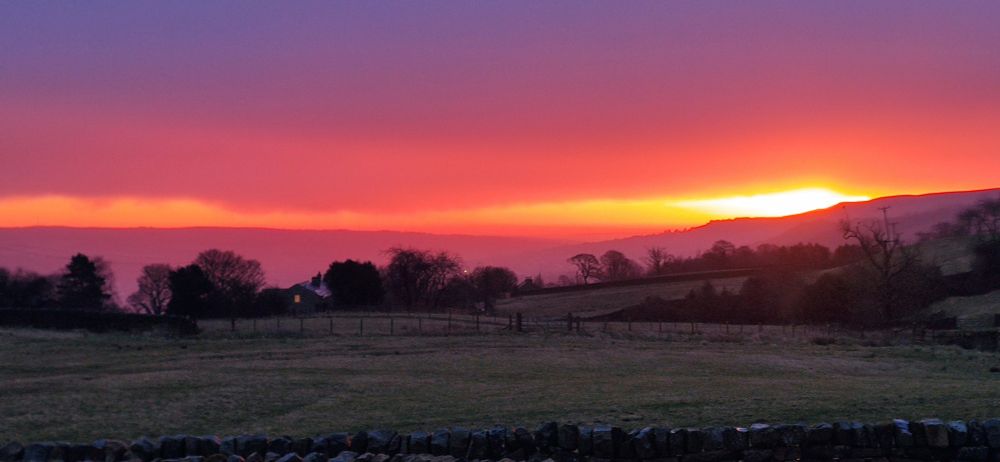 Deep pink sunrise with rain