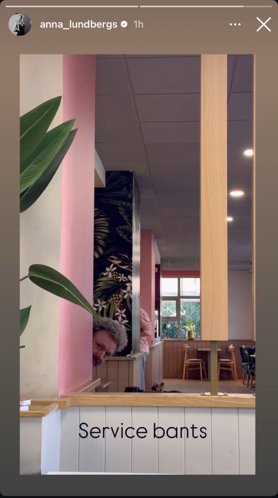Michael Sheen peeking from behind a wall