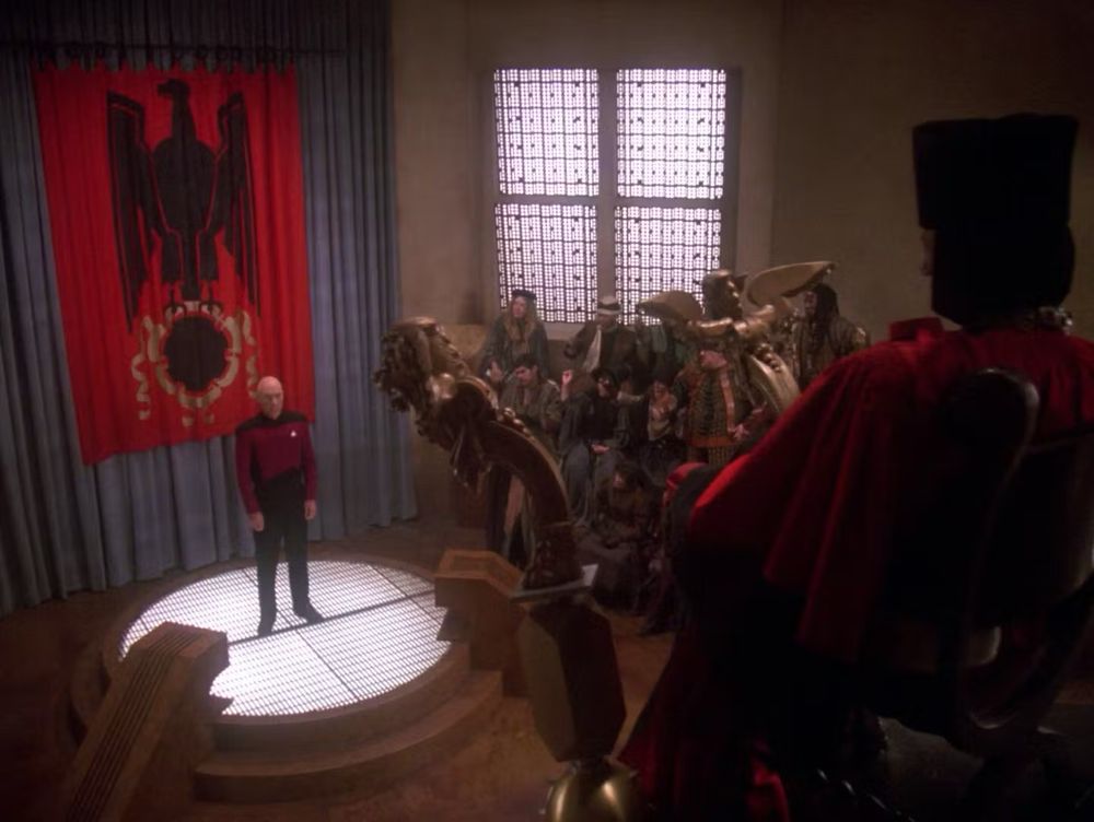 Star Trek the next generation episode with Q sitting as a judge of humanity, represented by Captain Picard on a stage before him.
