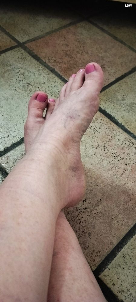 A photo of A-o-D's feet crossed, but showing the freshly painted nails. 
